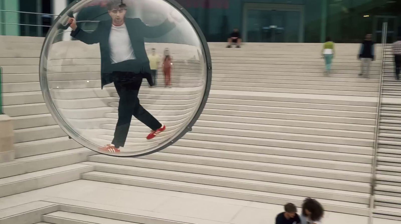 a man is walking in a glass ball