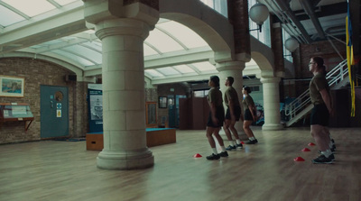 a group of people standing on top of a hard wood floor