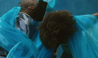 a man in a blue dress and a woman in a blue dress