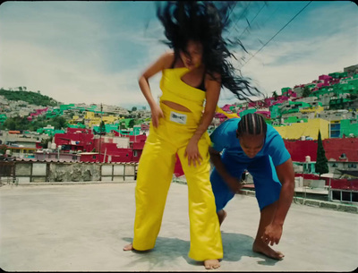 a woman in a yellow outfit and a man in a blue shirt