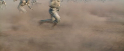 a blurry photo of a baseball player running in the dust