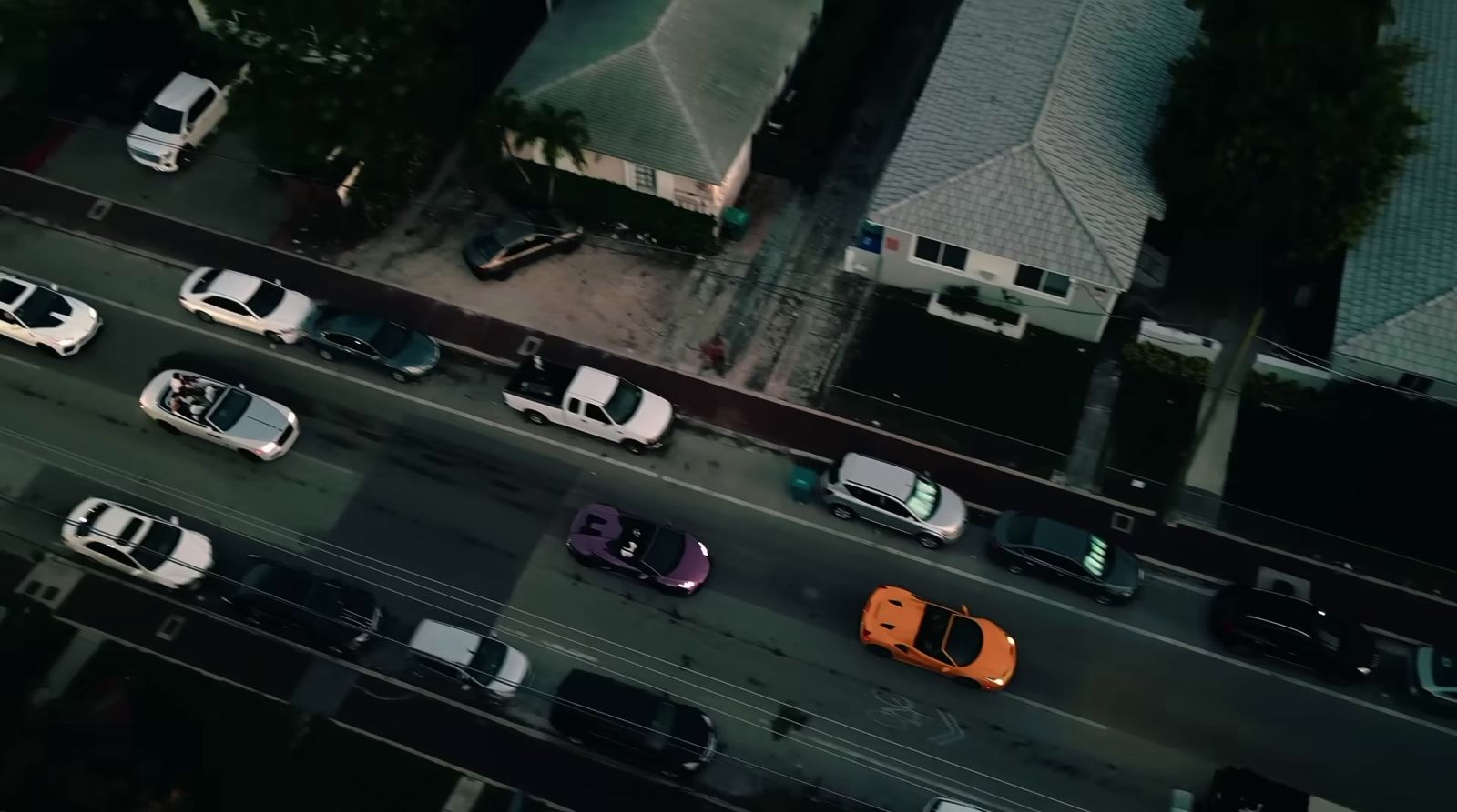 an aerial view of a city street with many cars