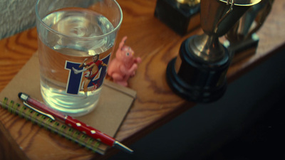 a glass of water sitting on top of a wooden table