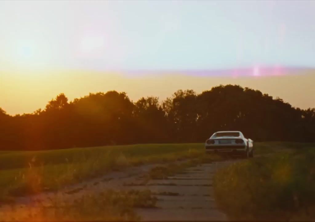 a car is parked on a dirt road