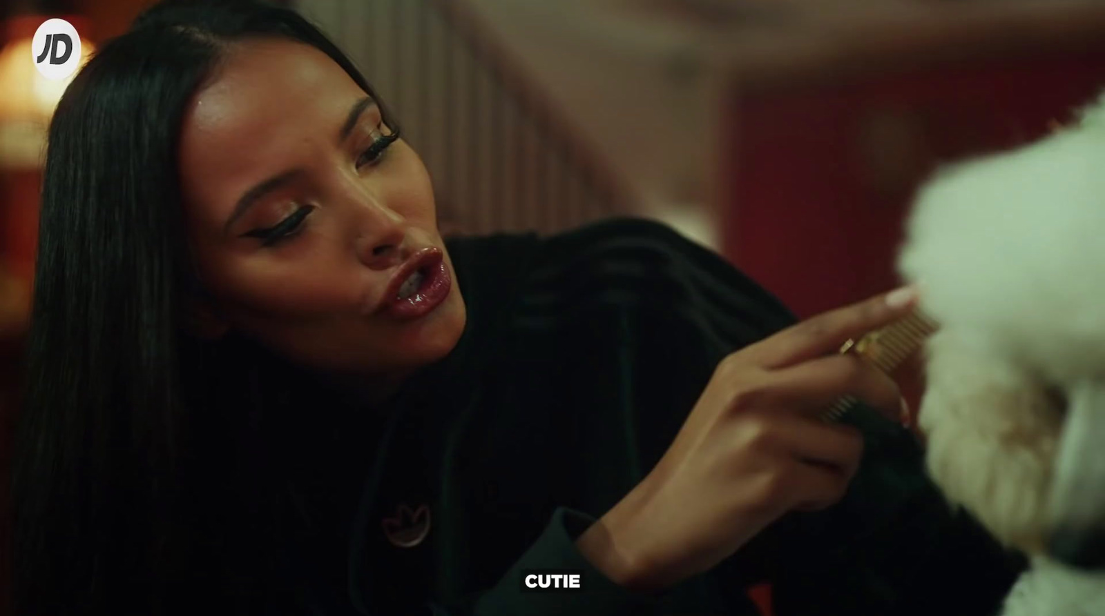 a woman brushing her hair with a brush