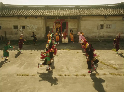 a group of people dancing in front of a building