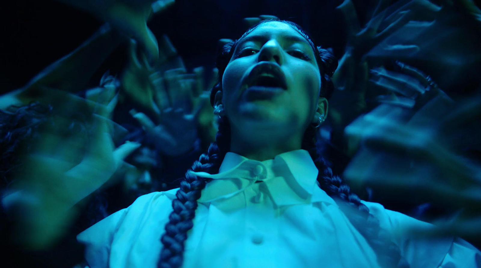 a woman with braids and a white shirt