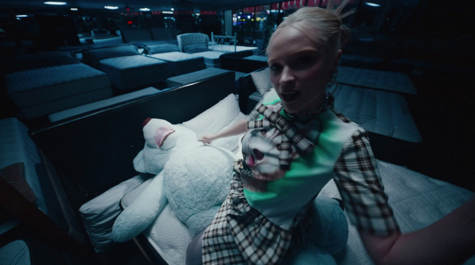 a woman sitting on a bed with a stuffed animal