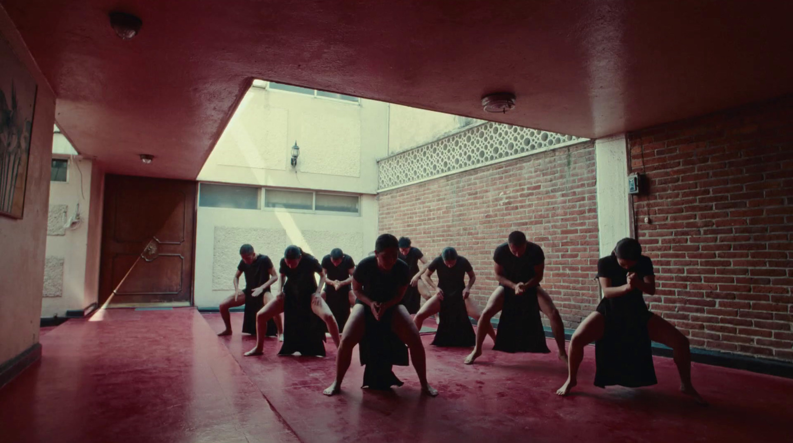 a group of women in a room with a brick wall