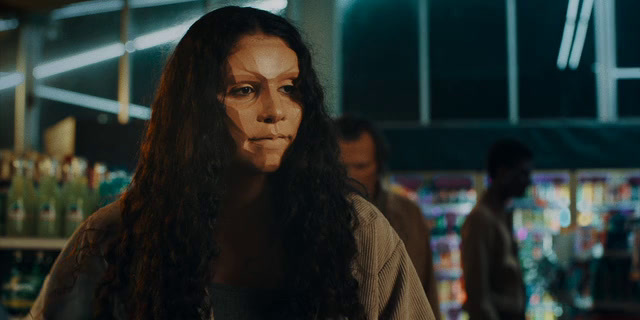 a woman with long hair standing in a store