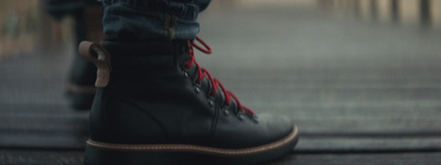 a close up of a pair of black boots with red laces