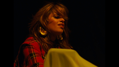 a woman standing at a podium with a microphone