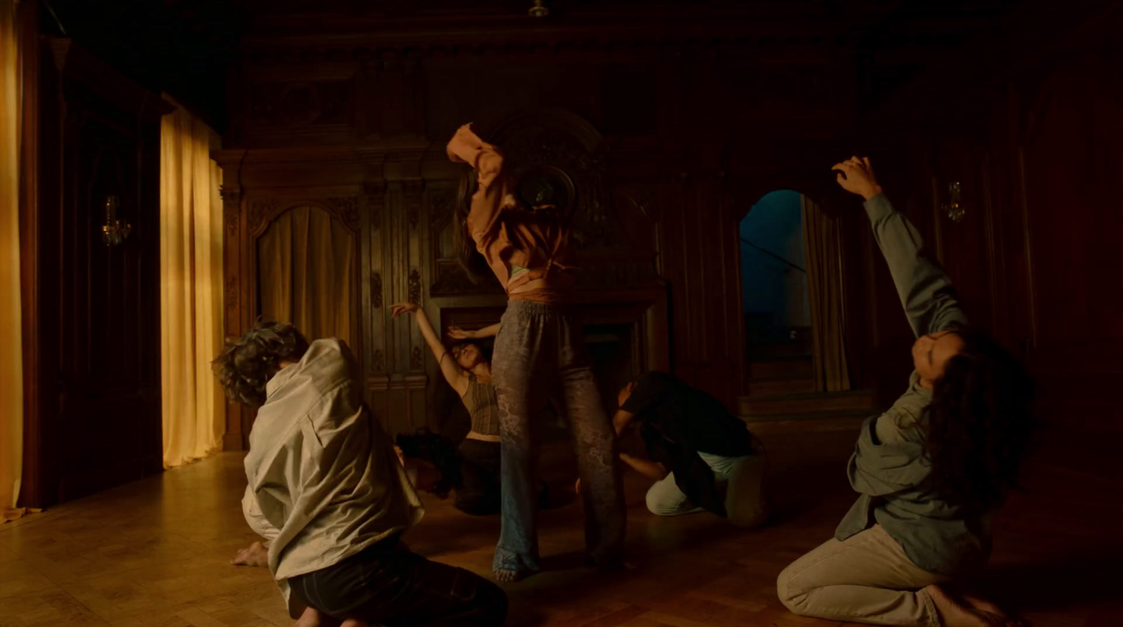 a group of people doing yoga in a dark room