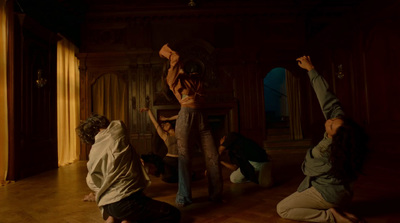 a group of people doing yoga in a dark room