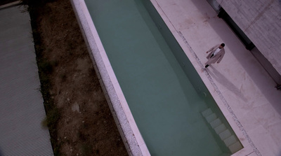 an empty swimming pool in the middle of a yard