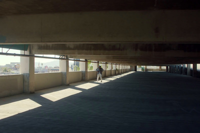 a person riding a skateboard under a bridge