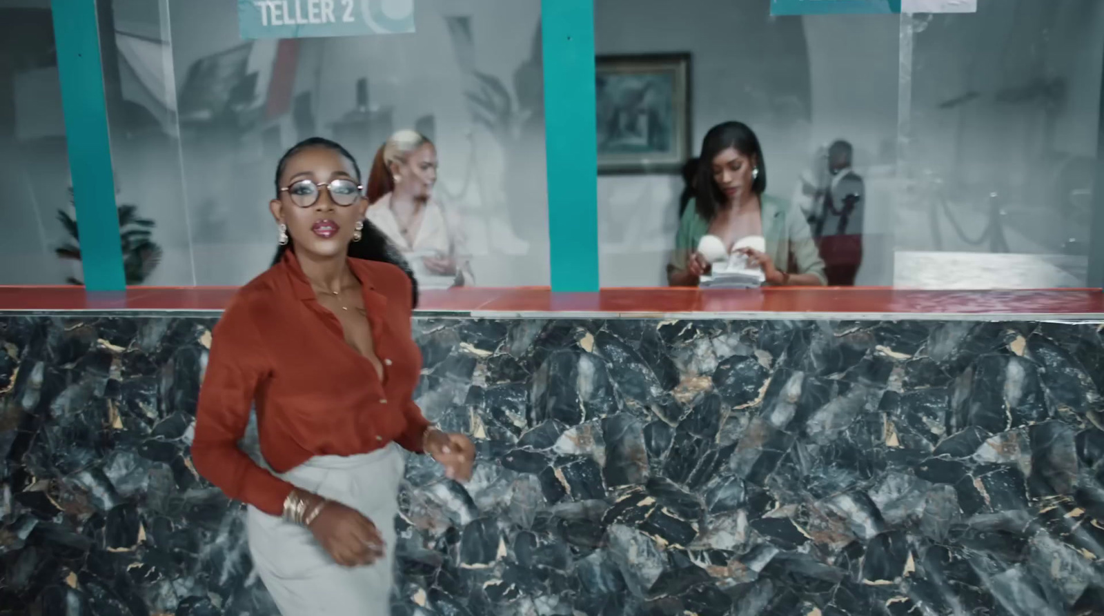 a woman standing in front of a marble counter