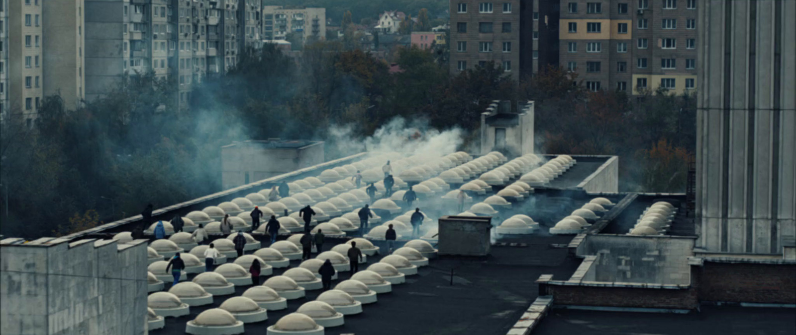 a group of people standing on top of a roof