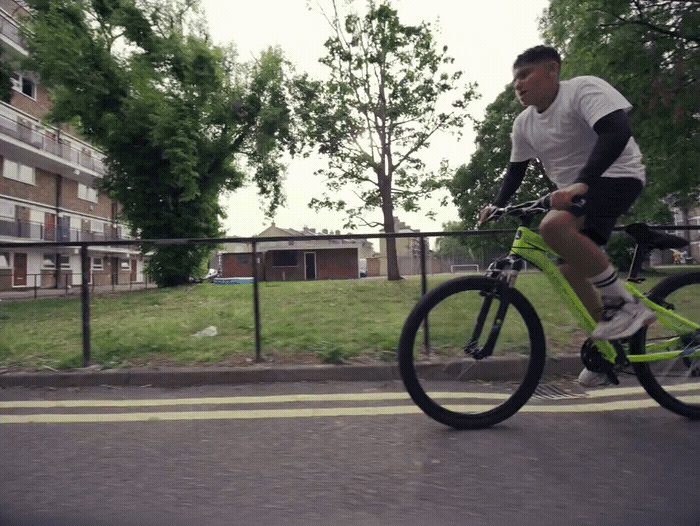 a man riding a bike down a street