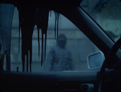 a person in a car with a lot of water on the windshield