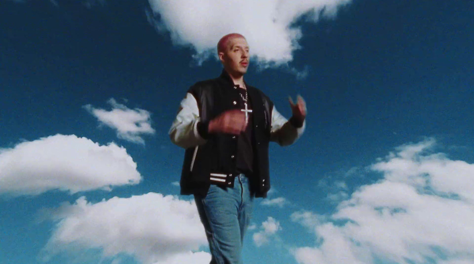 a man standing on top of a lush green field