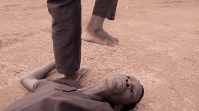 a man laying on the ground with his head on the ground