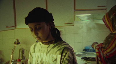 a woman standing in a kitchen next to a stove