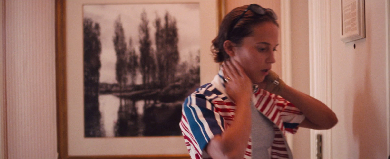 a woman is brushing her teeth in a room