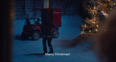 a person standing in the snow next to a truck