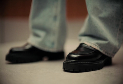 a close up of a person wearing black shoes