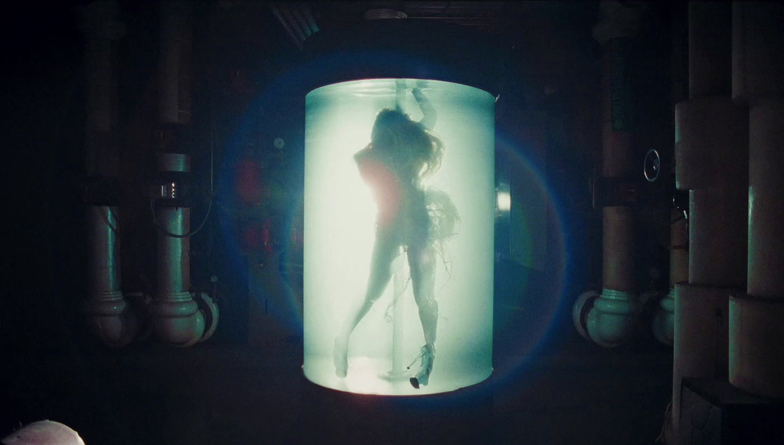 a woman is standing in a glass container