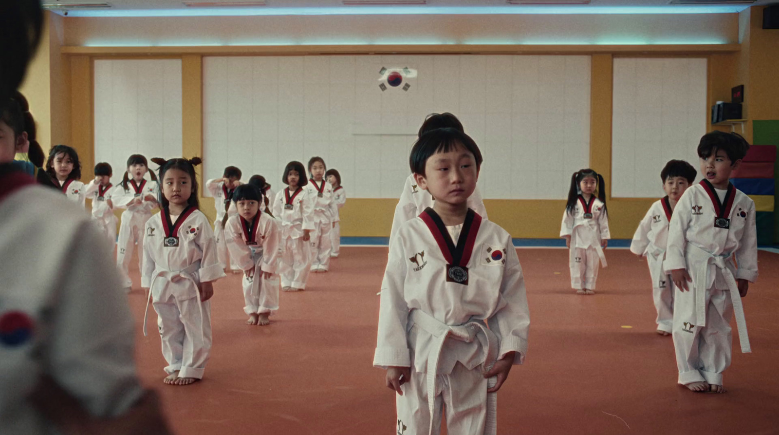 a group of young children in karate uniforms