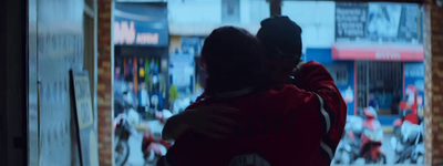 two people standing in front of a store window