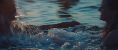 a woman swimming in a body of water