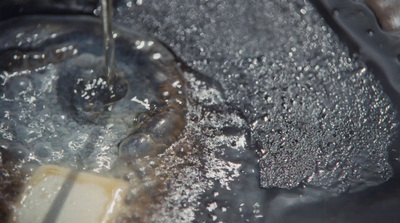 a close up of a sink filled with water