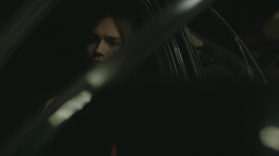 a man sitting in a car in the dark