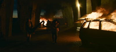 a car on fire in a dark street