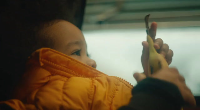 a child holding a banana in their hand