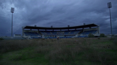 a large empty stadium sitting on top of a lush green field