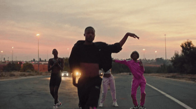 a group of people standing on the side of a road