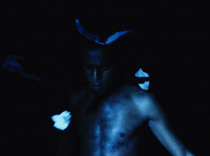 a shirtless man with blue paint on his body