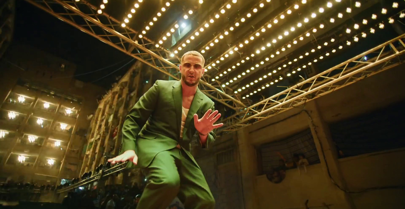 a man in a green suit is dancing