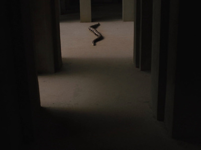 a skateboard is in the middle of a dark hallway