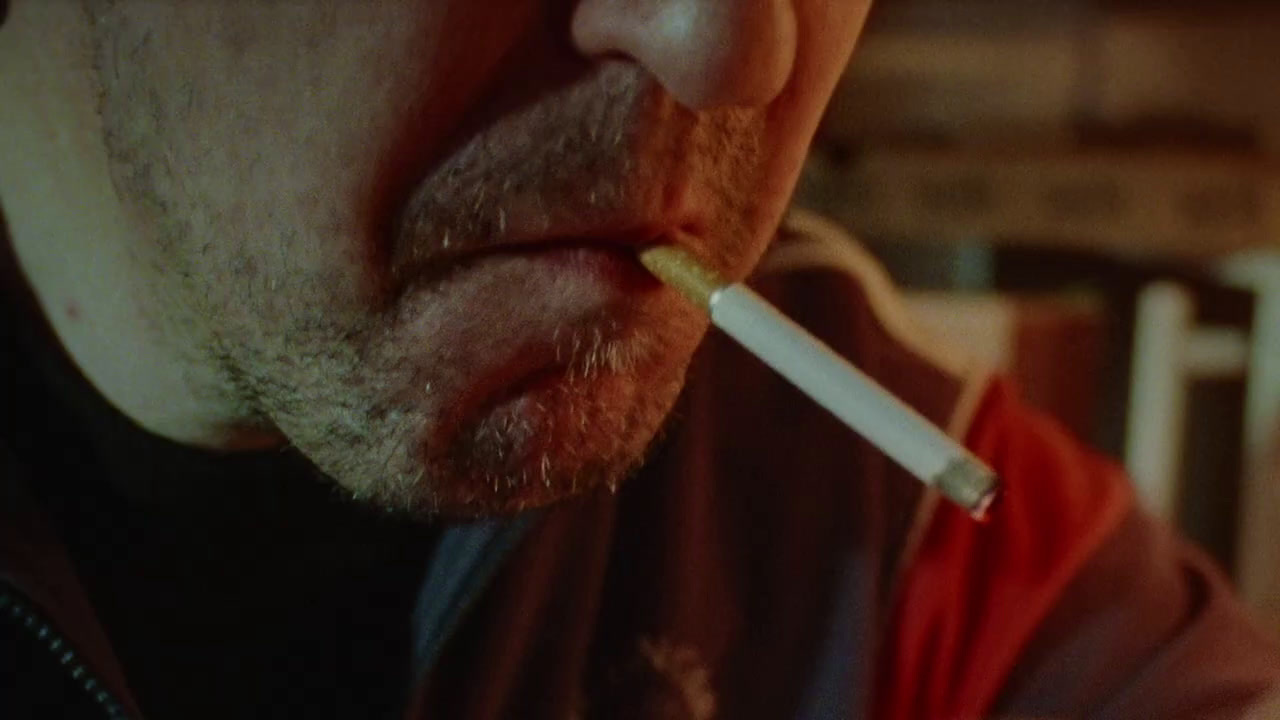 a man with a cigarette in his mouth