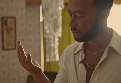 a man in a white shirt holding something in his hands