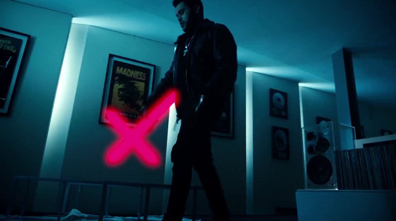 a man standing in a room with a red x on it