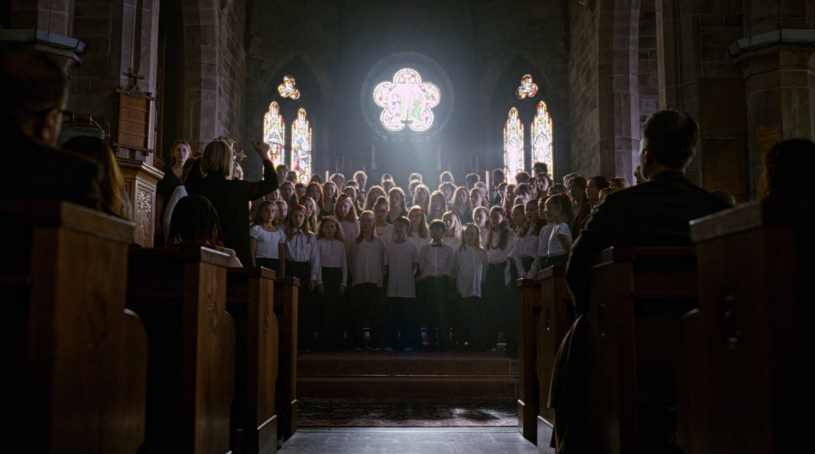 a group of people standing in front of a church