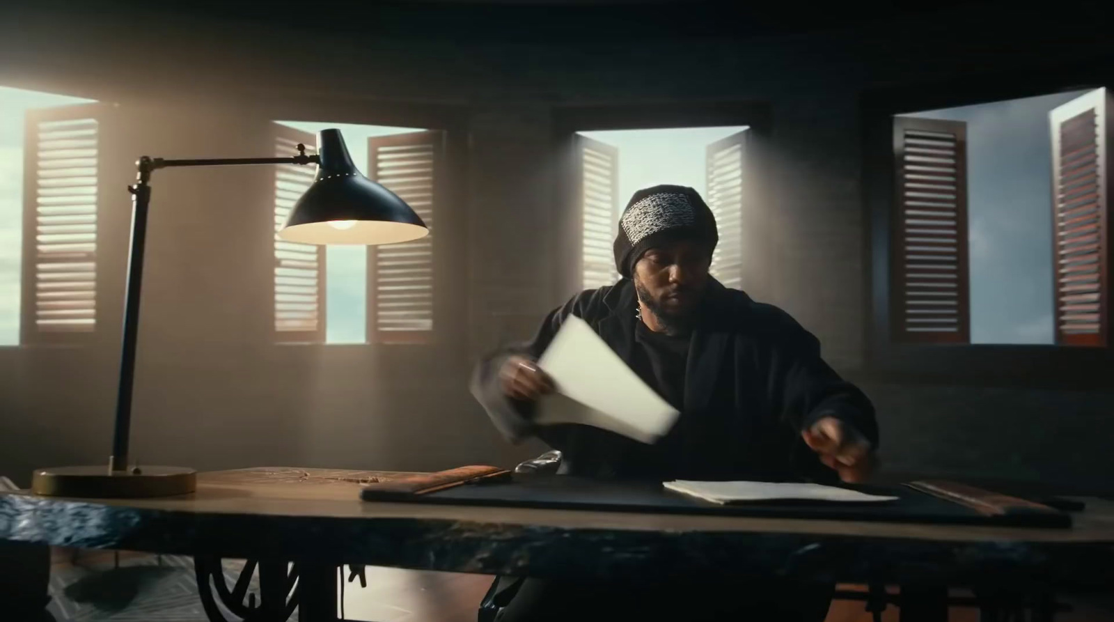 a man sitting at a desk with papers in front of him