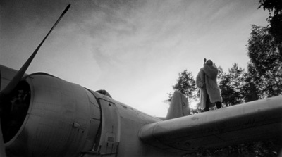 a man standing on the wing of an airplane