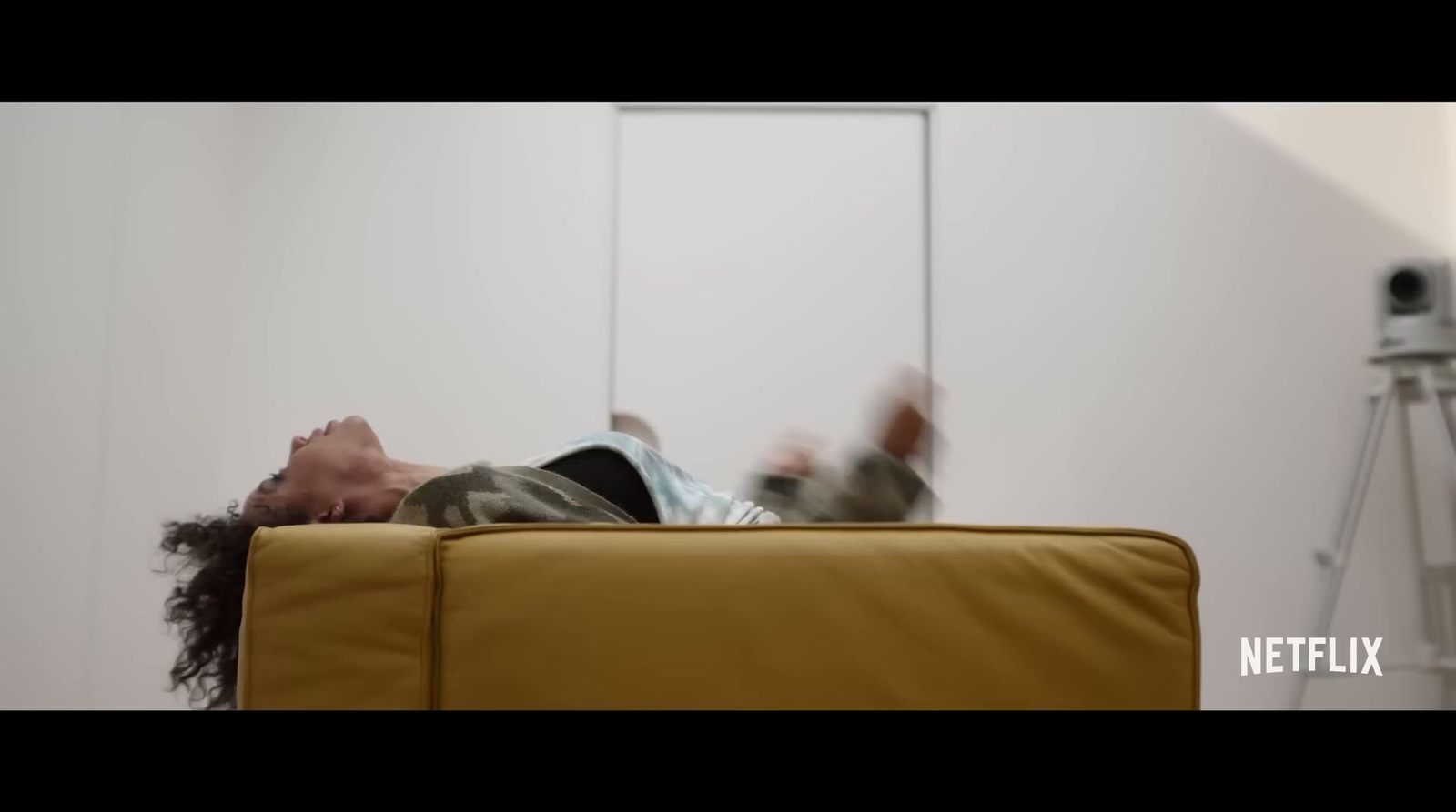 a person laying on a couch in a room